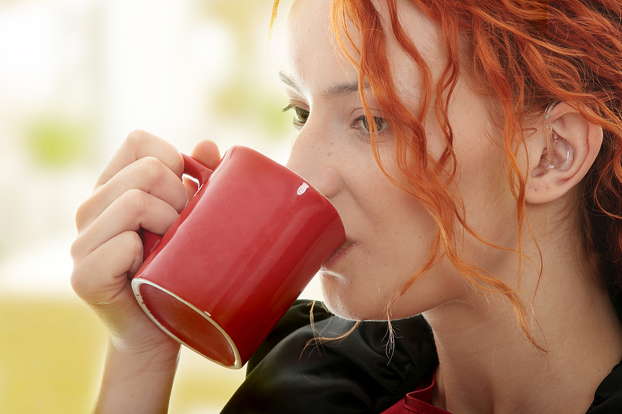 Woman drinking hot coffee.