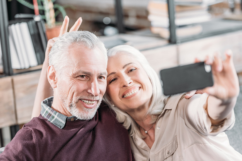 happy senior couple smiling for selfie