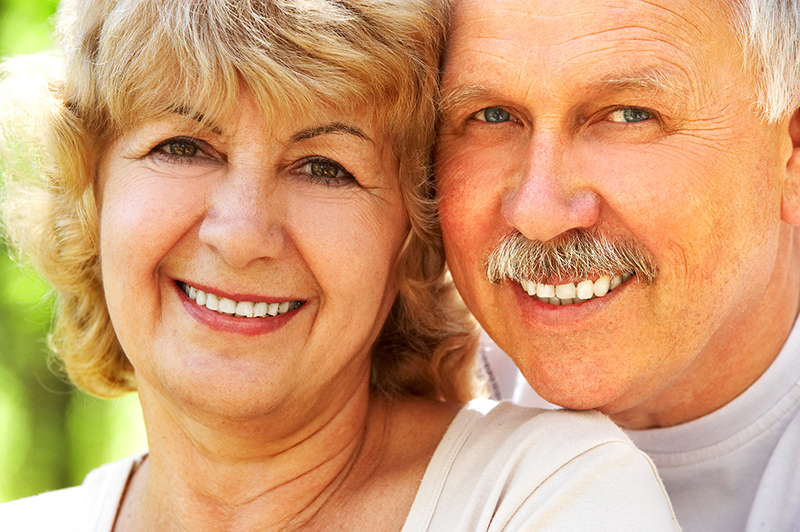senior elderly couple with dental implants