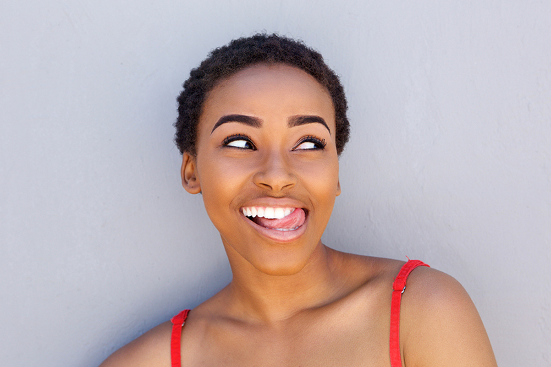 woman feeling teeth with tongue