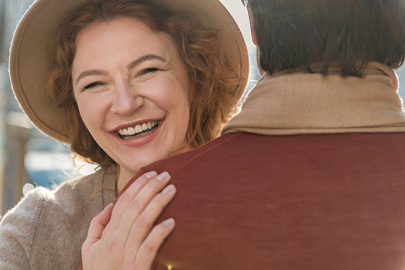 smiling woman with possible anterior dental crowns